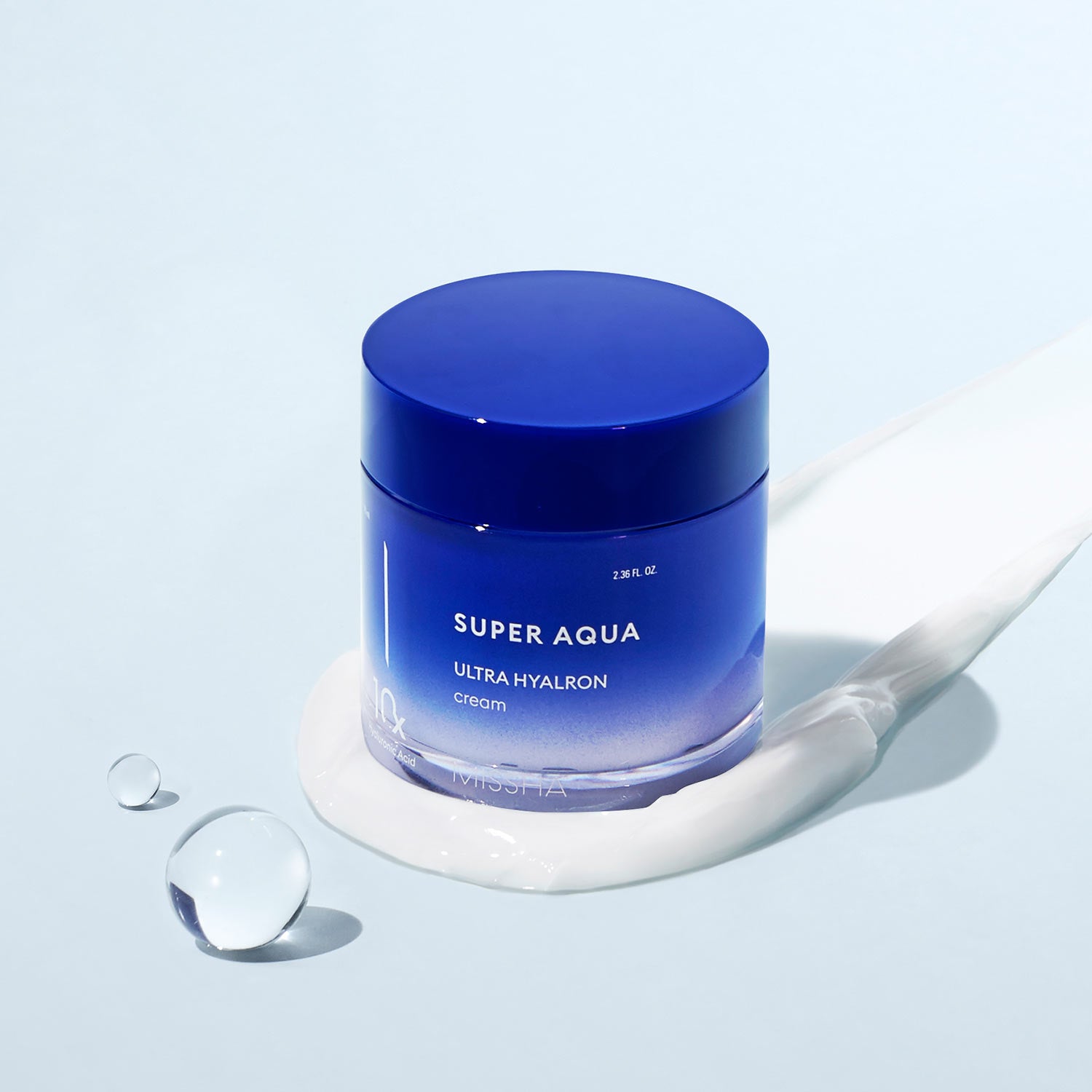 A jar of 'Super Aqua Ultra Hyalron Cream' by Missha, predominantly blue in color with white and grey text, indicating the product is a hydration cream designed to retain moisture in the skin.