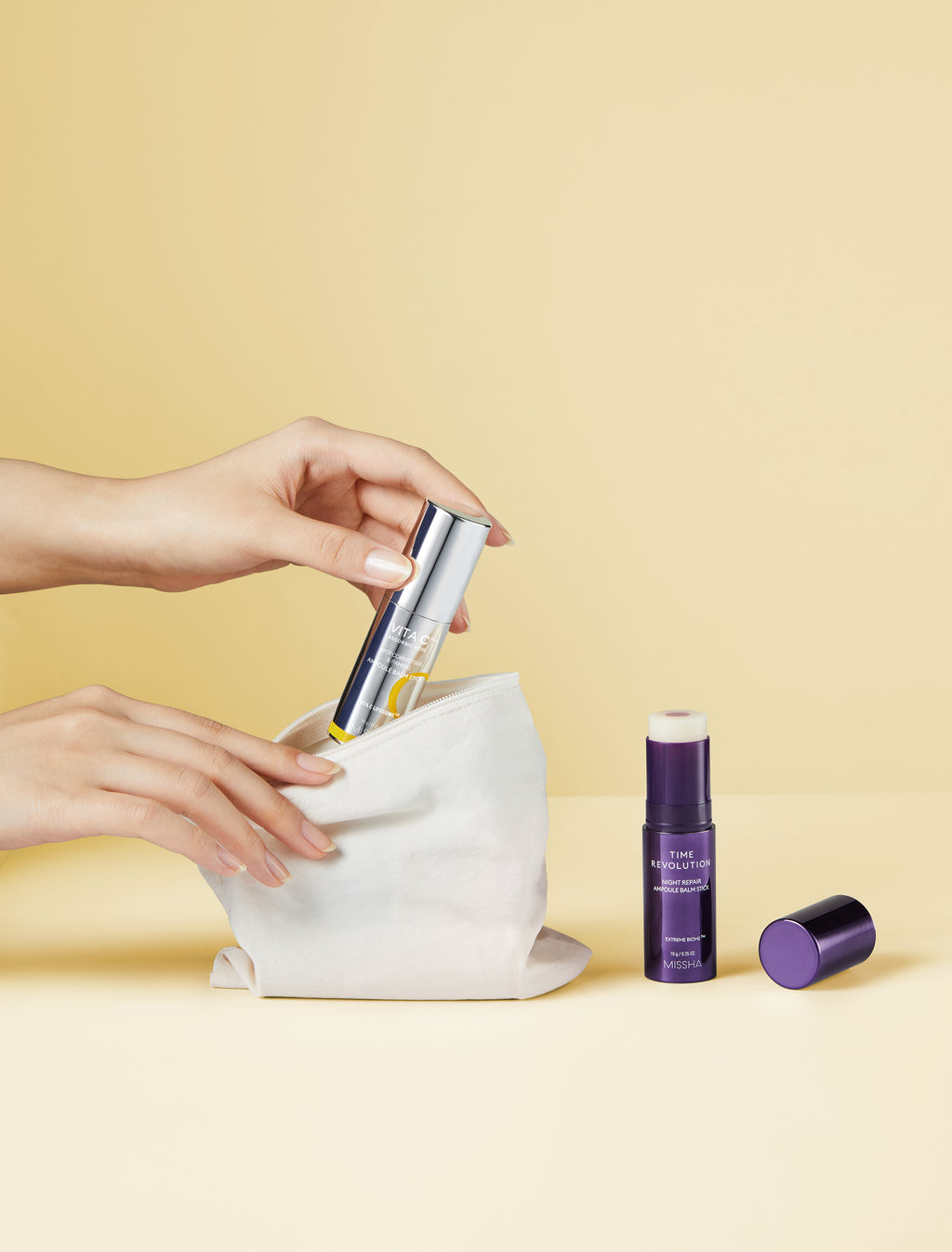 The Vita C Balm Stick (yellow side) for Dark Spot Eraser with the Night Repair Balm Stick (purple side) for Wrinkle Eraser which are both in the picture. This highlights the key ingredients: Pure Vitamin C, Peptides, and VITA C LIPOSOME for firmness and brightening.