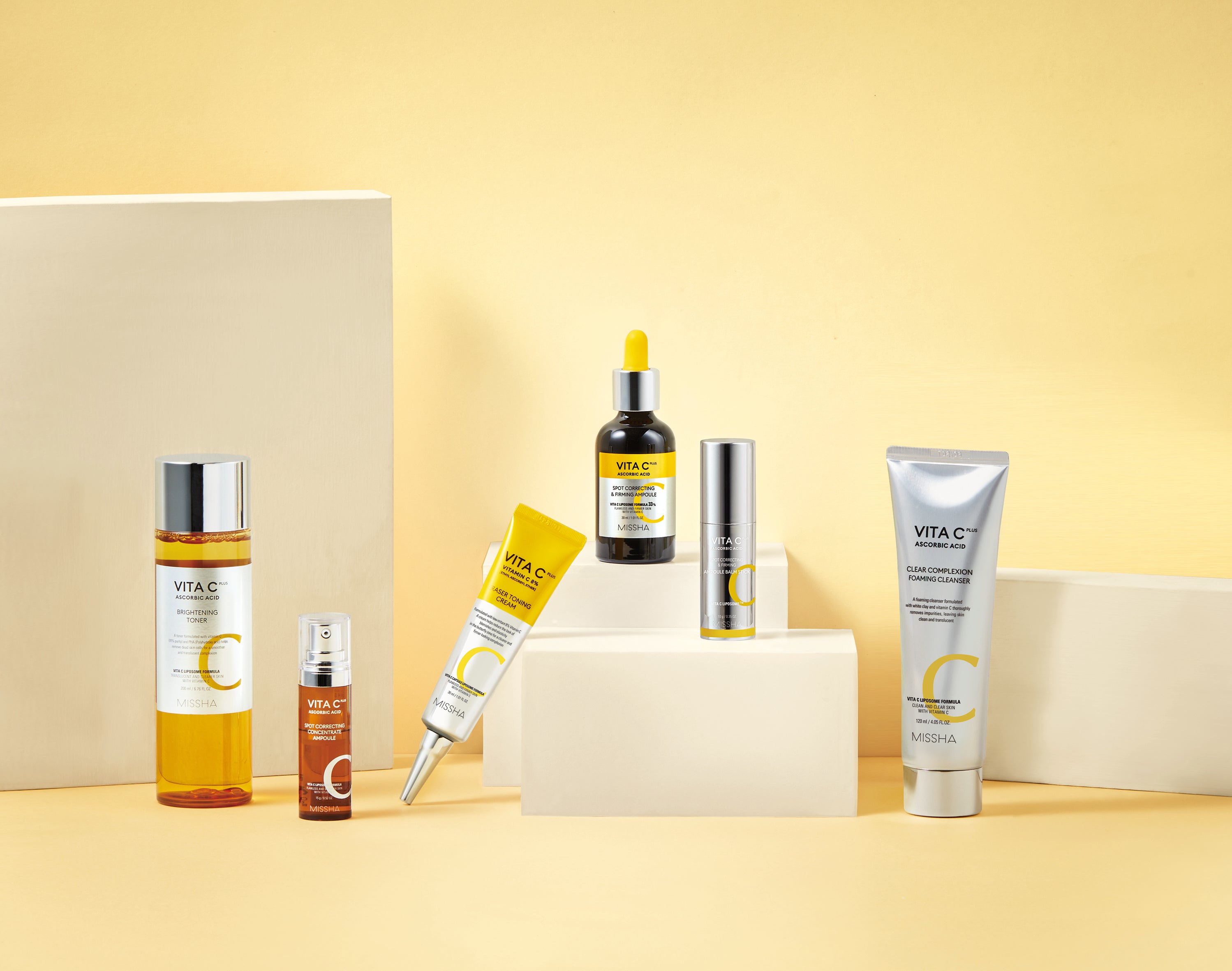 A display of the full Missha Vita C Plus line, including the Toner, Ampoule, Eraser Toning Cream, and the new Spot Correcting & Firming Ampoule Balm Stick. This shows the complete Vitamin C-rich routine for tackling dark spots and dullness.
