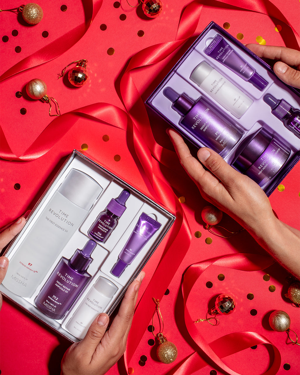 MISSHA Time Revolution skincare gift sets displayed on a festive red background with ribbons and ornaments, featuring The First Essence and Night Repair collections in elegant purple and white packaging
