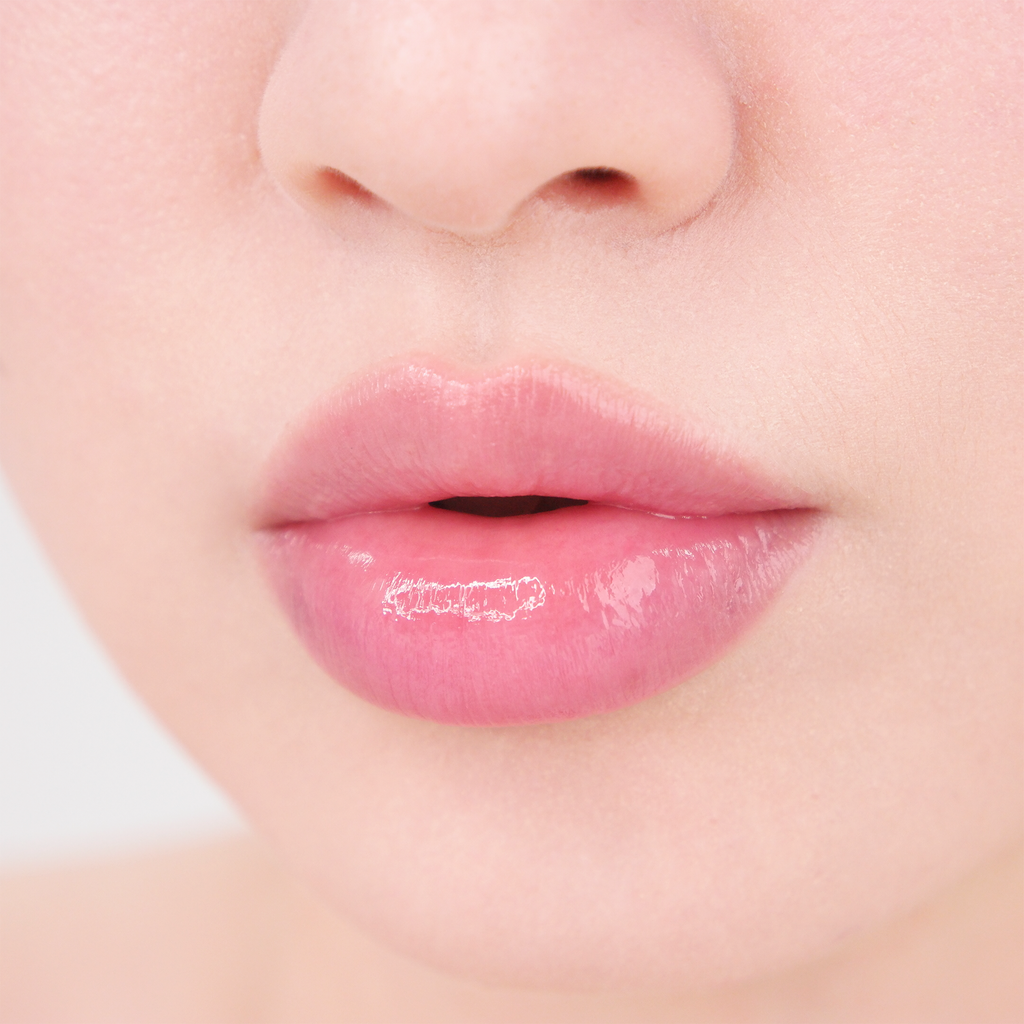 Close-up of glossy, hydrated lips with a natural pink finish, showcasing the smooth moisture effect of MISSHA lip care