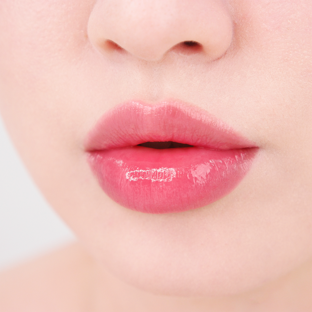 Close-up of glossy pink lips showcasing the moisturizing and plumping effect of MISSHA Glow Lip Tint for a smooth, radiant finish