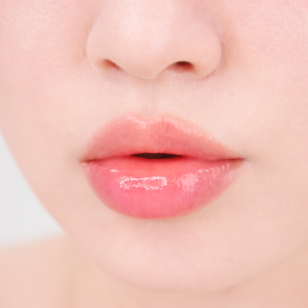 Close-up of soft pink glossy lips showing the smooth, hydrated finish of MISSHA Glow Lip Tint.
