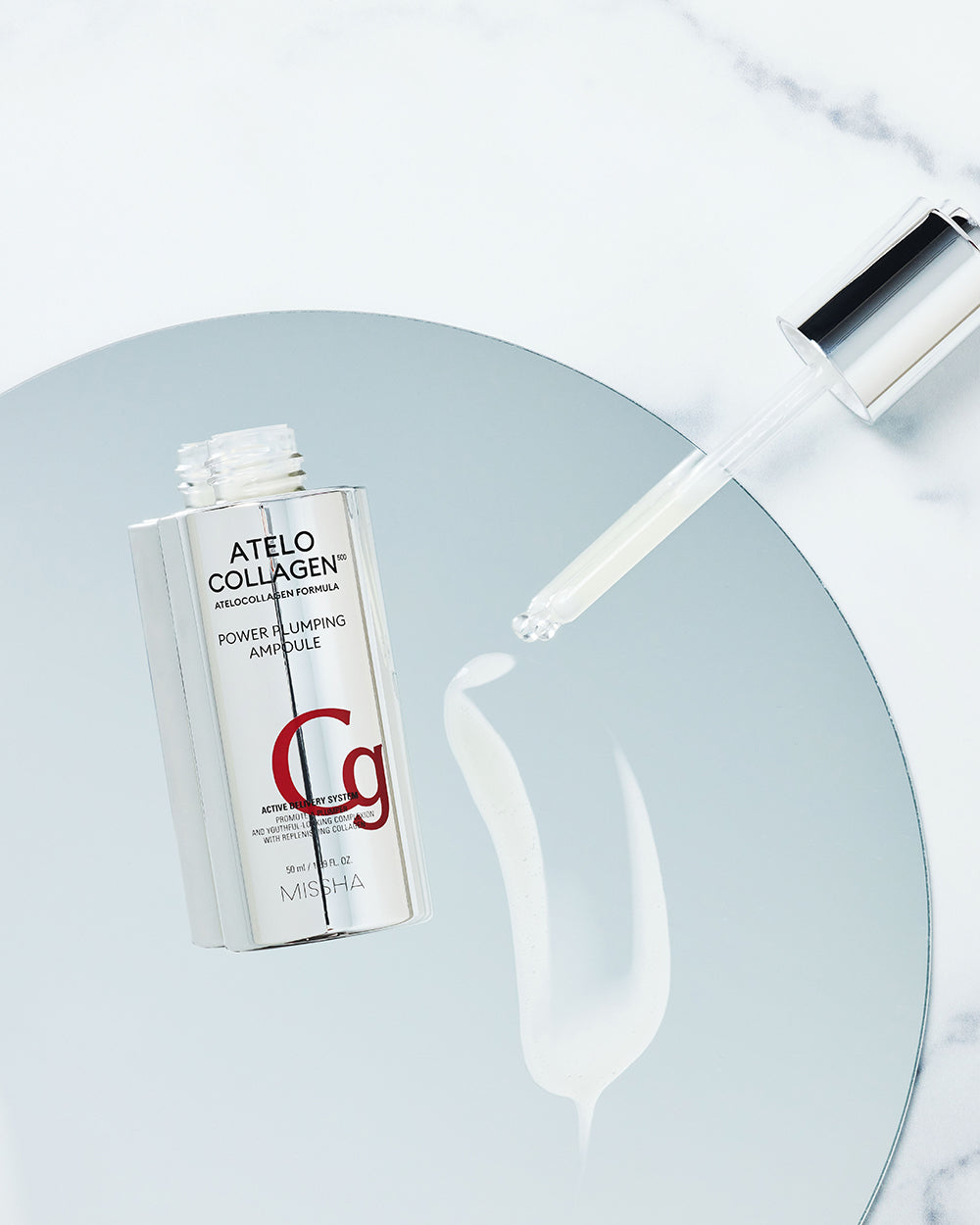 MISSHA Atelo Collagen 500 Power Plumping Ampoule with dropper and creamy serum texture, highlighting atelocollagen formula for firm, hydrated skin