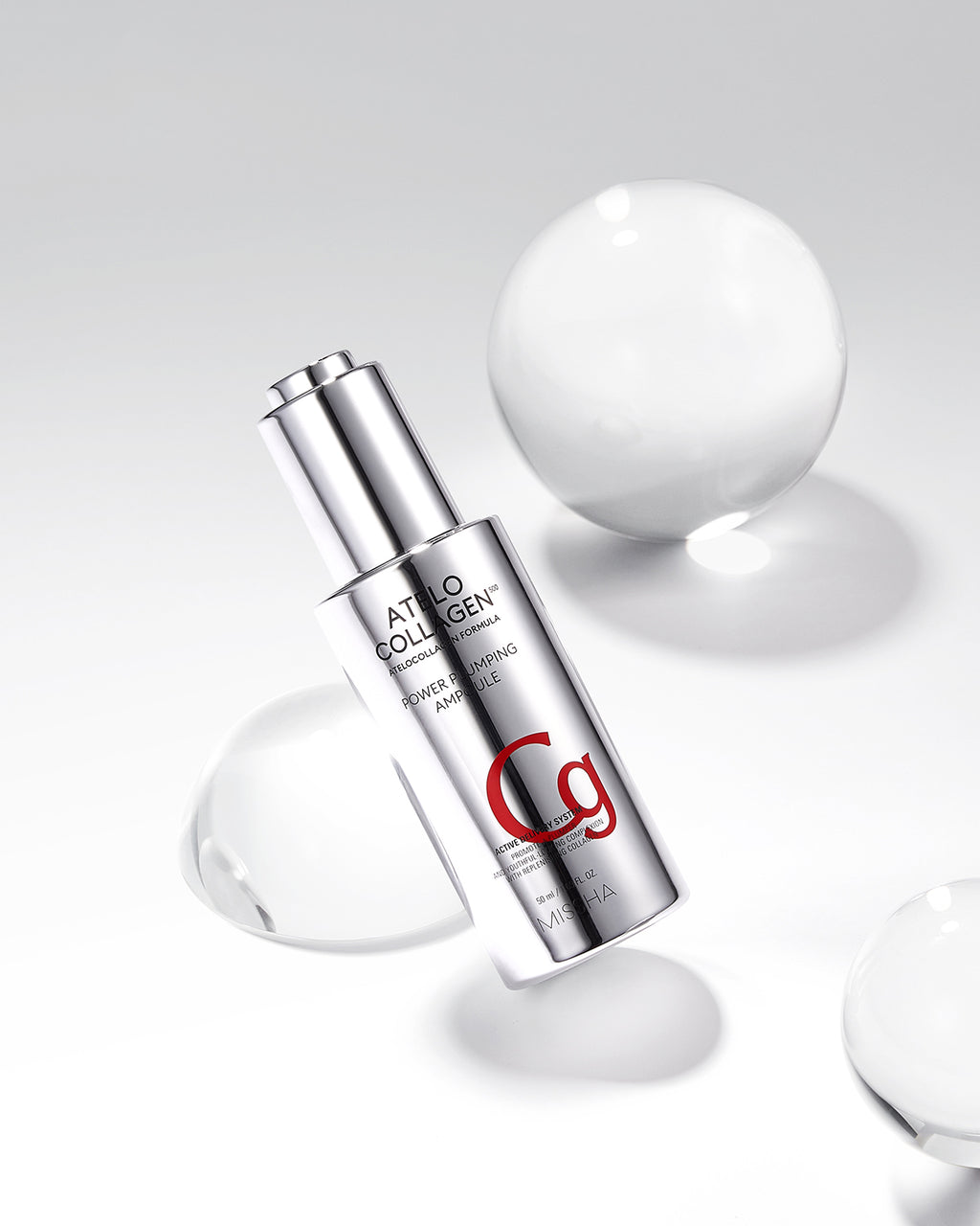 A silver ampoule labeled 'C9' from the Atelo Collagen brand, designed for skincare benefits, displayed with water droplets around it.