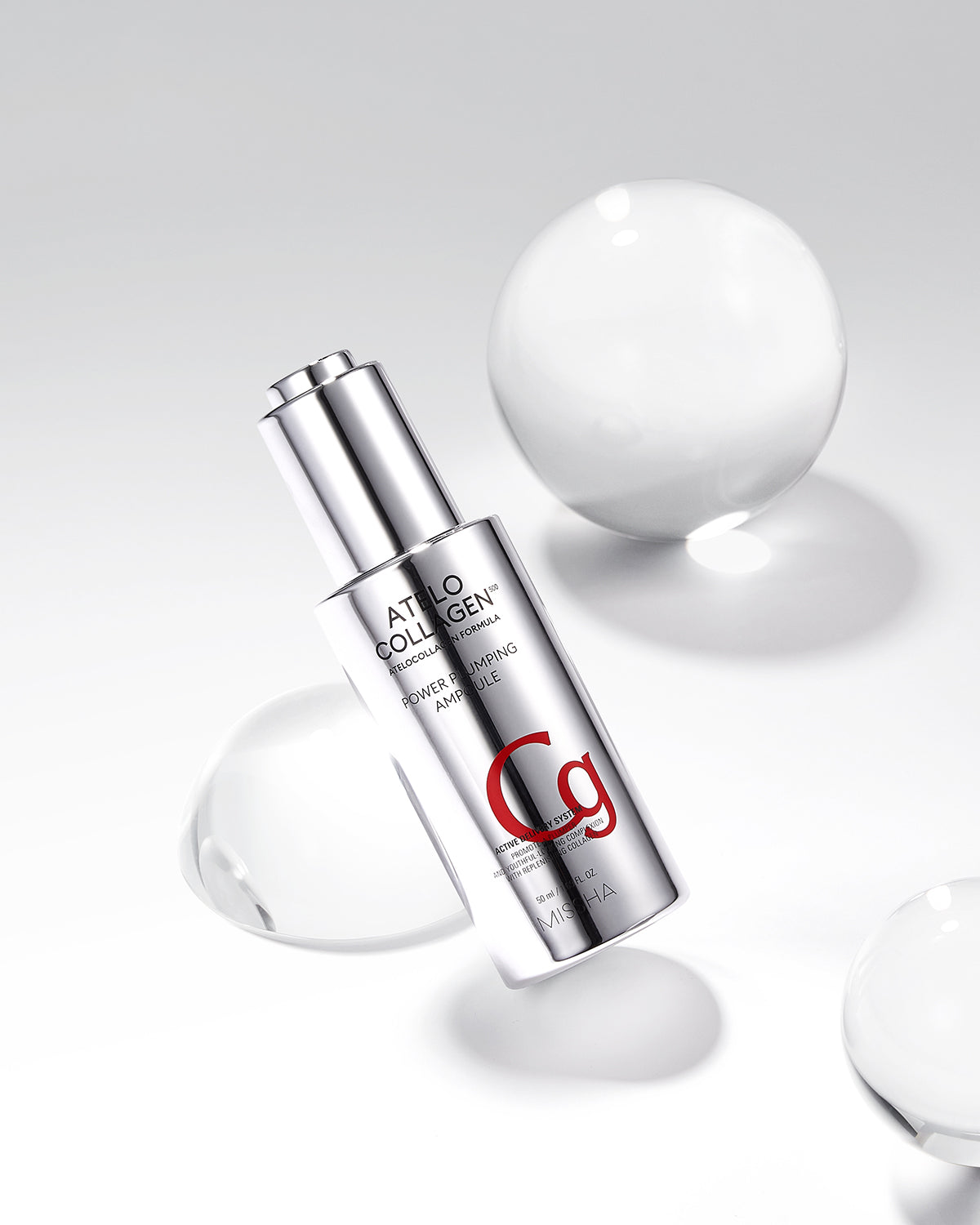 A silver ampoule labeled 'C9' from the Atelo Collagen brand, designed for skincare benefits, displayed with water droplets around it.