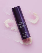 MISSHA Time Revolution Night Repair Ampoule Balm Stick with Extreme Biome™ formula shown on textured pink background, highlighting its melting dual-balm texture for firming and wrinkle care