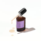 A dark amber bottle of the Missha Night Repair Ampoule 5X with the dropper cap removed, casting a shadow and featuring the light purple label. The milky serum is seen dripping onto the surface, highlighting the repair and anti-aging serum's consistency.