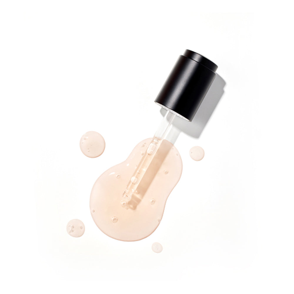 Overhead view of a black-capped dropper resting in a puddle of the light pink/peach Missha Time Revolution Primestem 100 Lifting Serum. The image showcases the smooth, viscous texture of the K-beauty lifting serum.