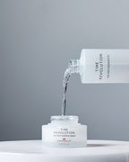MISSHA Time Revolution The First Essence 5X being poured into The First Essence Cream 60 jar, highlighting Extreme Ferment α™ and β™ synergy for deep hydration and radiance.
