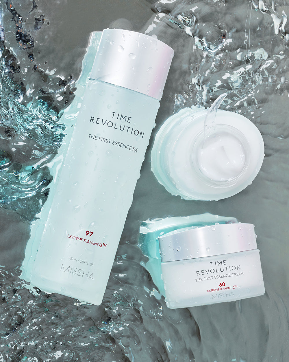 MISSHA Time Revolution The First Essence 5X and The First Essence Cream 60 with Extreme Ferment technology, showcased with water droplets symbolizing deep hydration and radiance